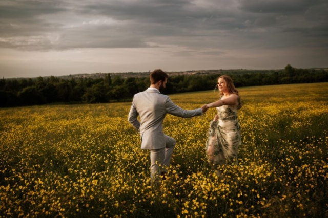 Bride and groom in field of flowers